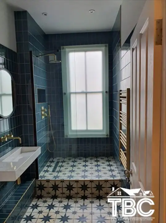Blue bathroom with a sash window and star floor tiles
