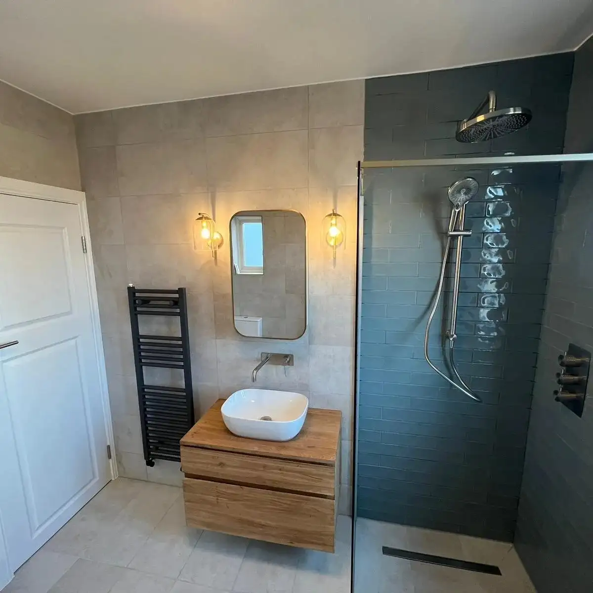 Walk-in shower with wall lights and oak vanity