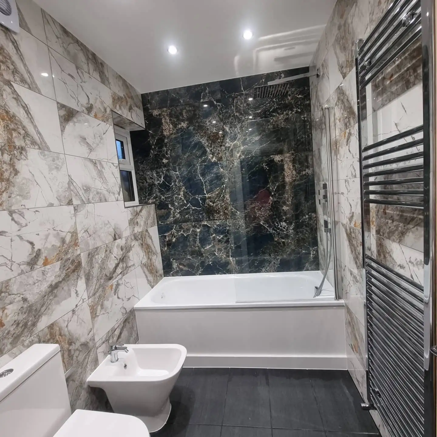 Marble-effect bathroom with bath and bidet