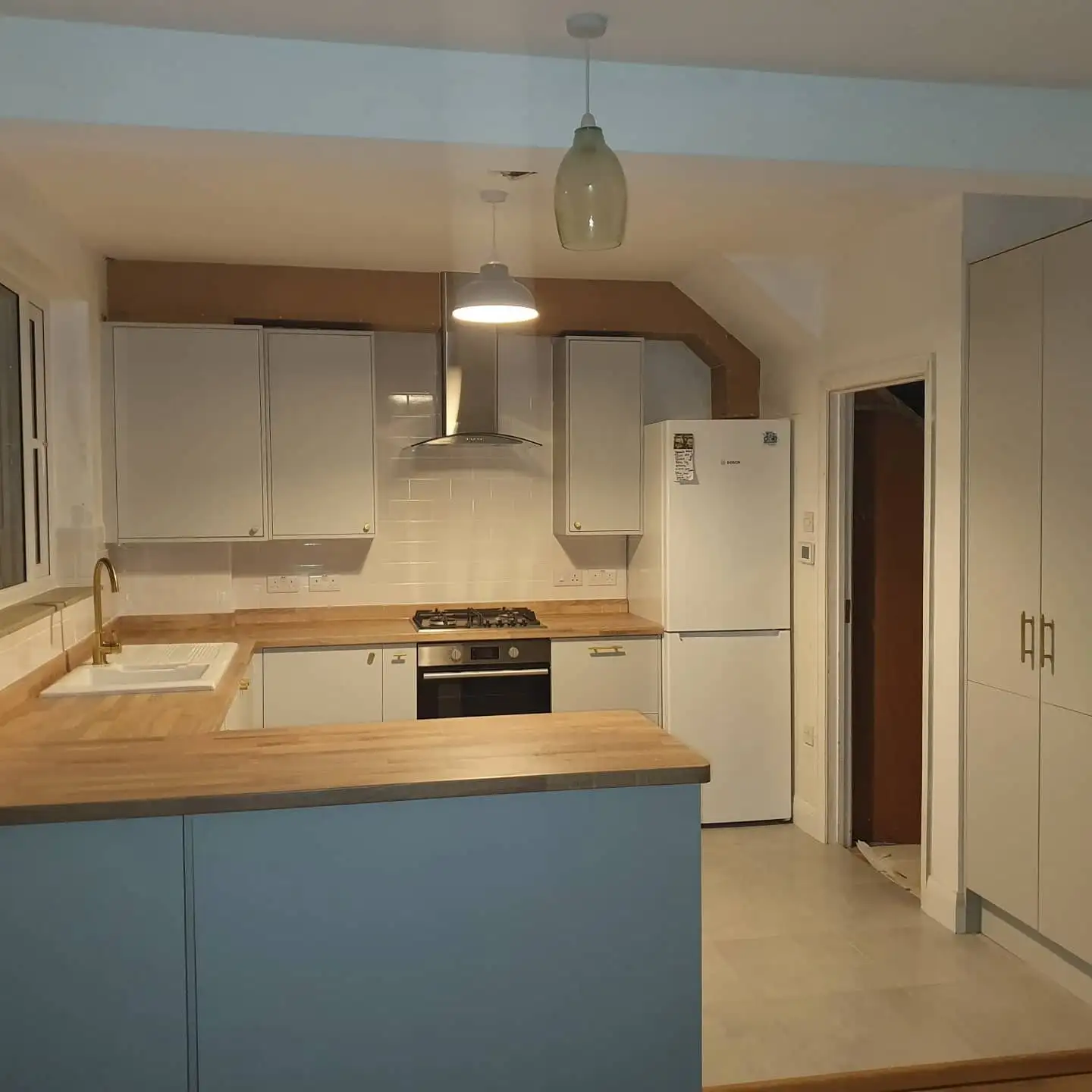 Blue kitchen with oak worktops