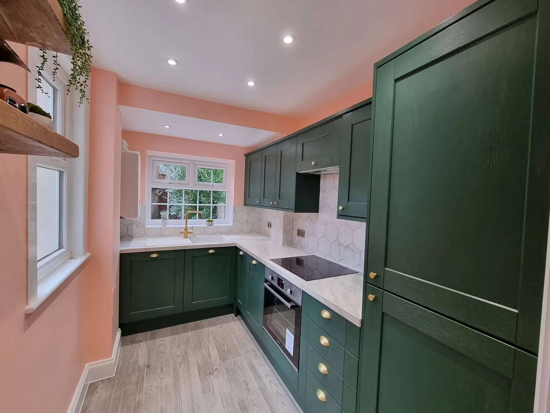 Green shaker kitchen with brass handles