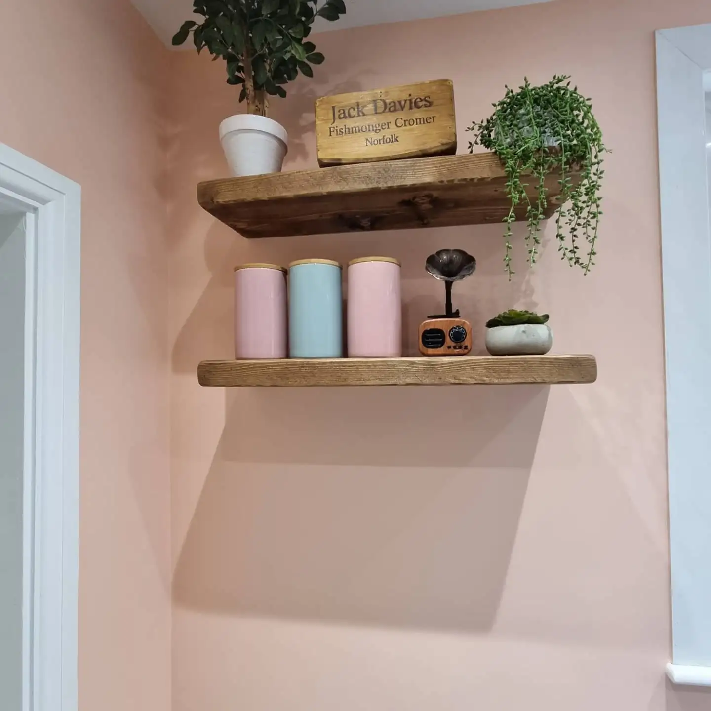 Floating shelves in the green kitchen