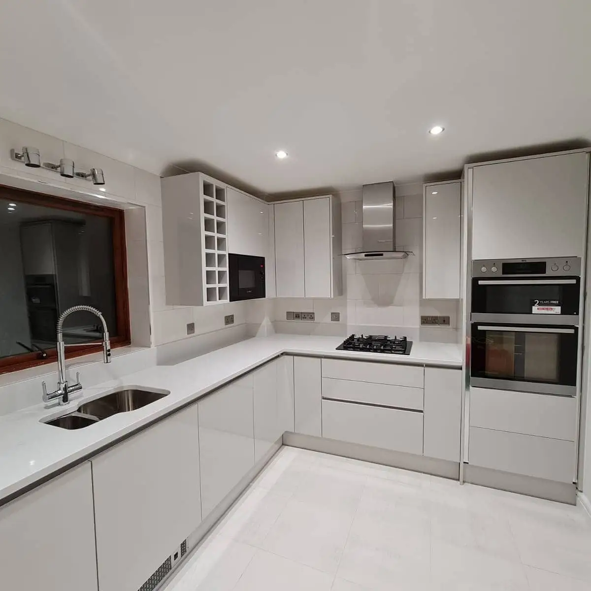 White gloss kitchen with a double oven