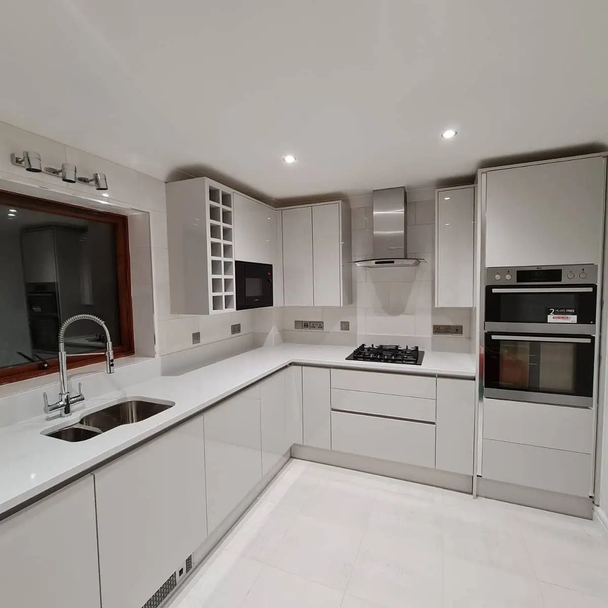 White gloss kitchen with a double oven
