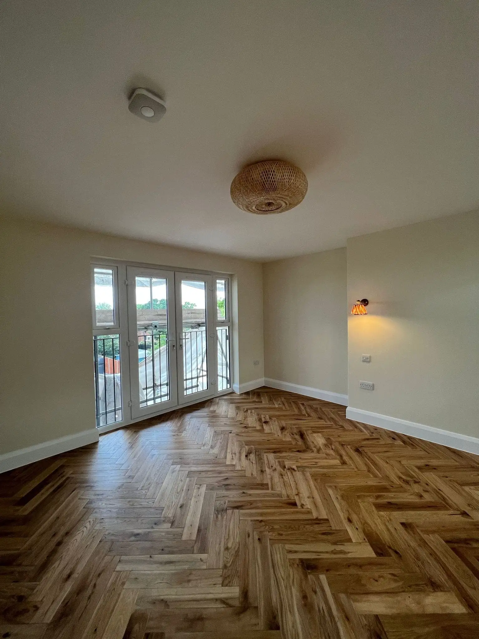 Loft conversion bedroom with French doors out to a balcony