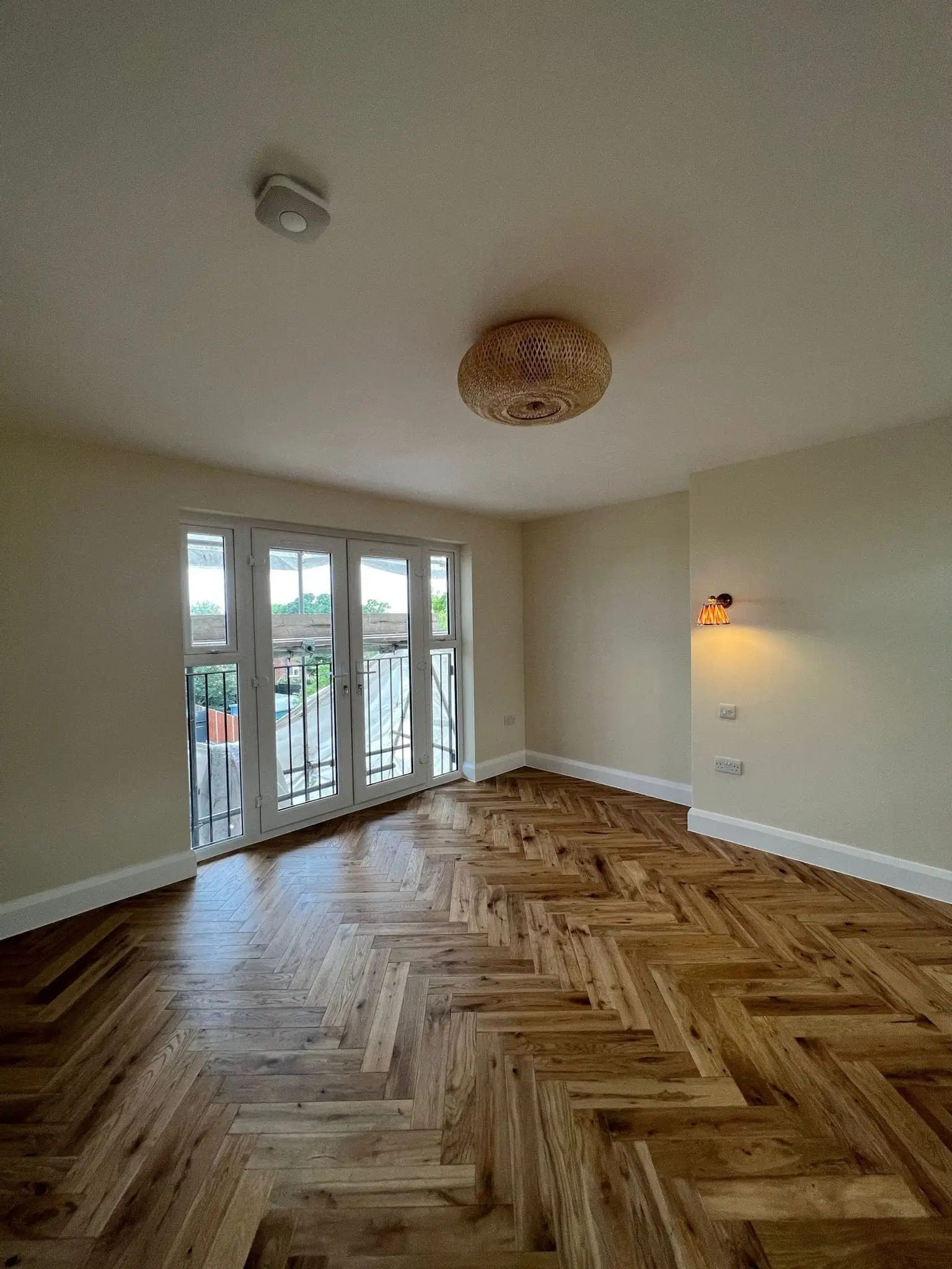 Loft conversion bedroom with French doors out to a balcony