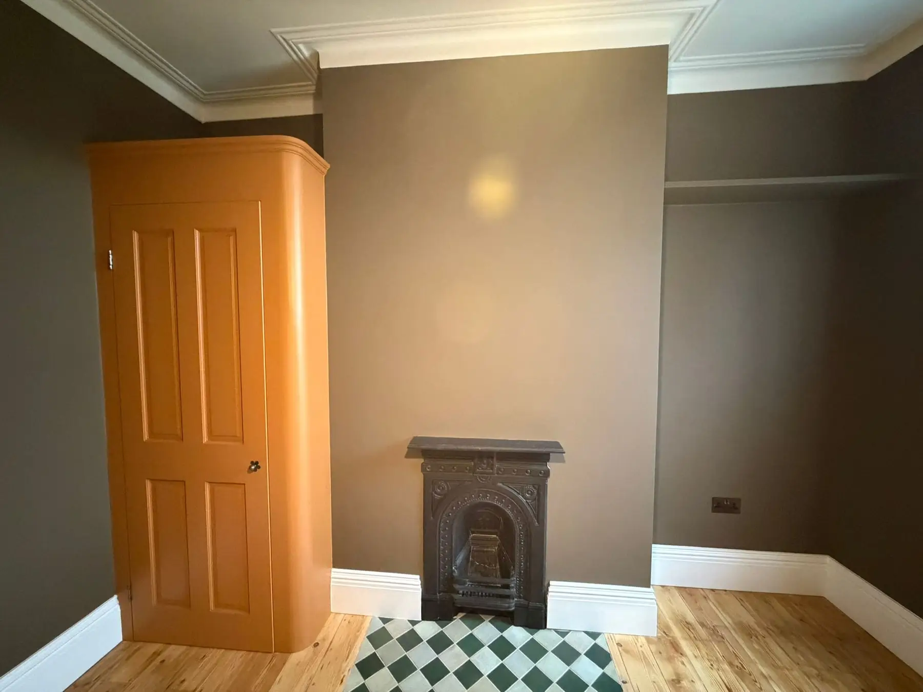 Bedroom with a cast iron fireplace and the new built-in cupboard